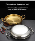 Golden and silver stainless steel wok pans with dual handles, displayed on dark surface with decorative elements, showcasing 