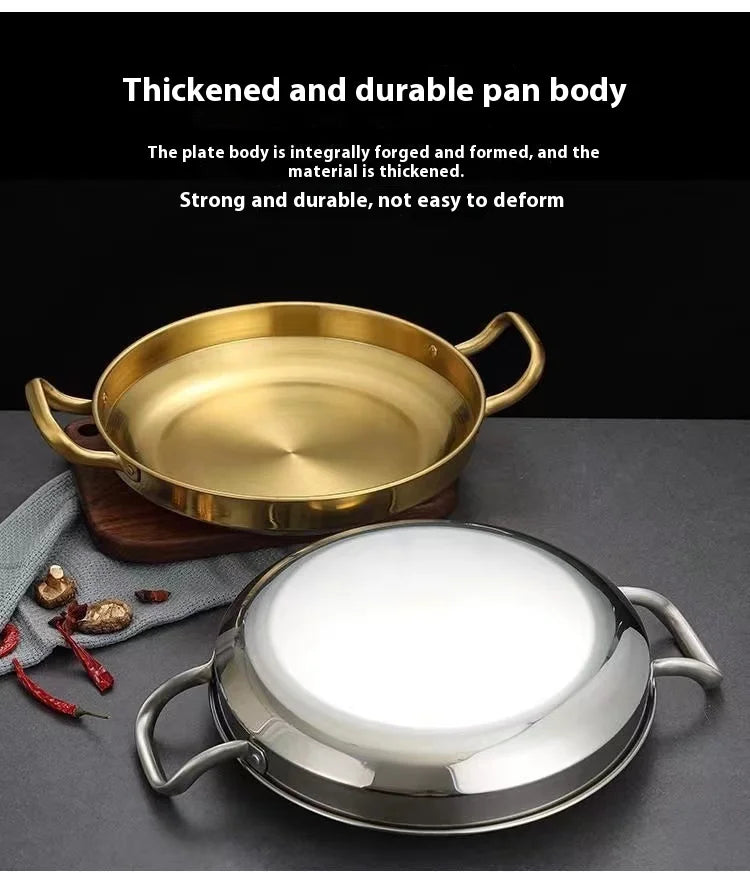 Golden and silver stainless steel wok pans with dual handles, displayed on dark surface with decorative elements, showcasing 