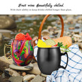 Colorful insulated copper travel cup with hammered finish, displayed on beach with fruit wine and picnic setup, keeping drink