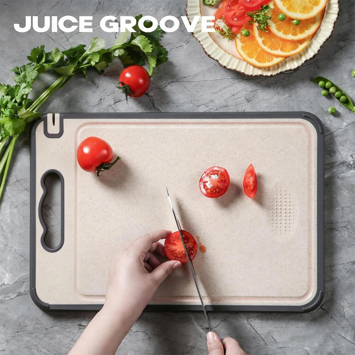 Stainless Steel Natural Cutting Board with slip-resistant grip, tomato being sliced, surrounded by fresh vegetables and citru