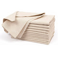 Stack of 12 natural cotton linen napkins in cream color with decorative brown trim, displaying soft woven texture and elegant