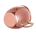Rose gold hammered Moscow mule mug with smooth circular front panel and rose gold handle against white background.