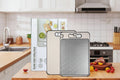 Double-sided cutting boards displayed in kitchen setting with stainless steel and natural surfaces, slip-resistant design vis