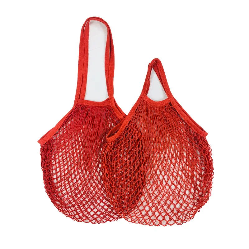 Red cotton mesh grocery bags with long handles, ideal for carrying fresh produce and shopping sustainably.