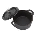 Black cast iron Dutch oven pot with lid and stainless steel knob, featuring dual handles for cooking and serving.