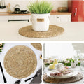 Handwoven round rattan placemat in natural tan color, heat-resistant and eco-friendly, styled in modern kitchen and dining se