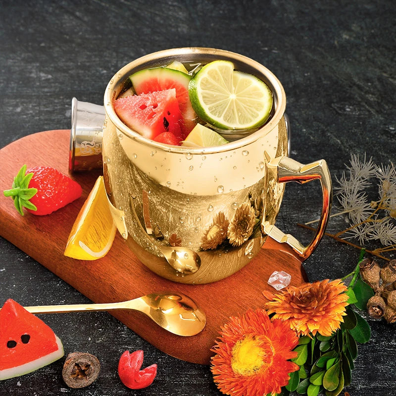 Hammered copper insulated travel mug filled with refreshing beverage, lime slice, and watermelon, styled with fresh flowers a