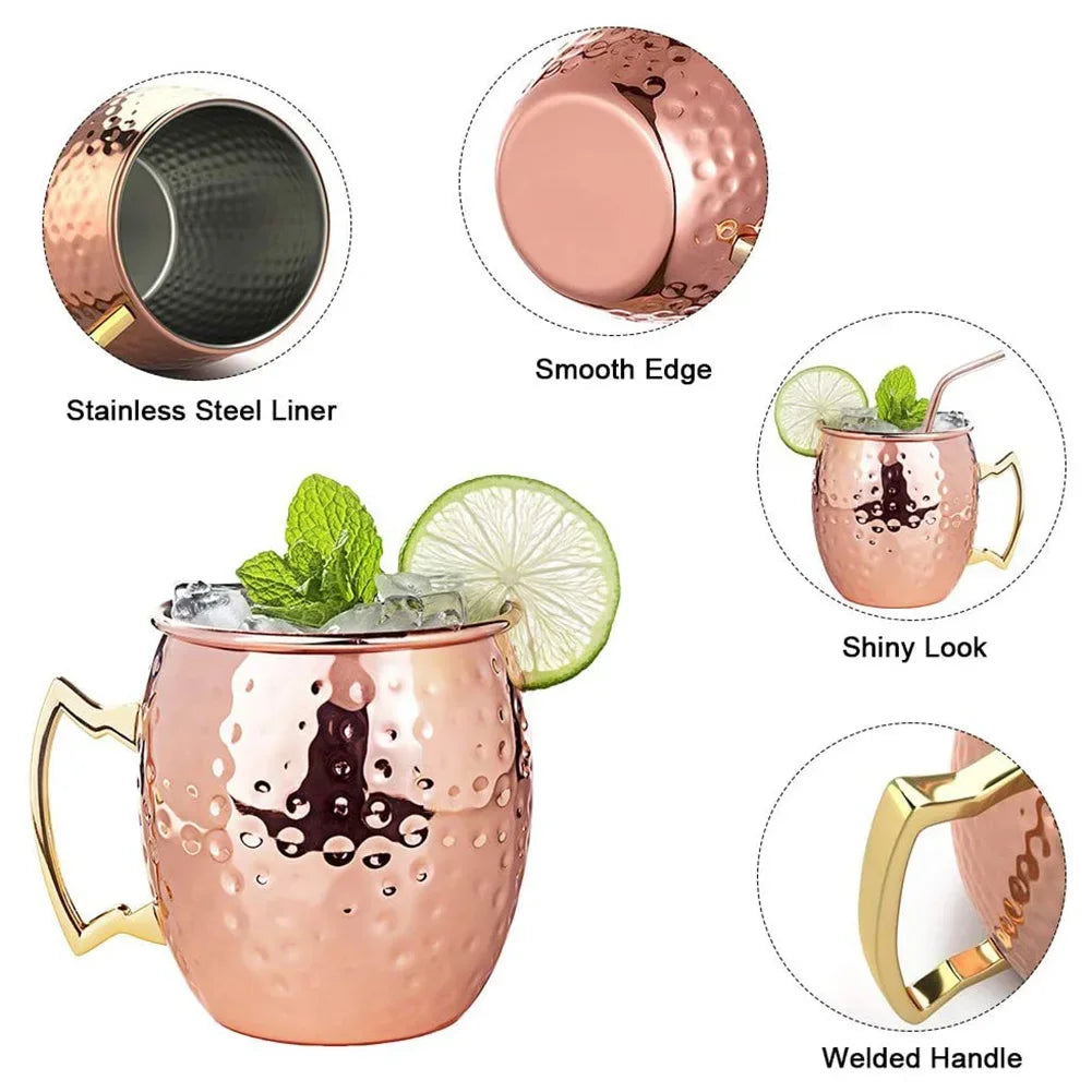 Copper Moscow mule mug with stainless steel liner, hammered finish, smooth rim, shiny exterior, welded brass handle, garnishe