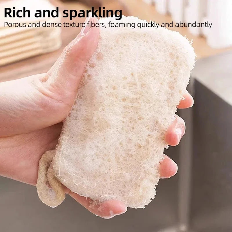 Natural loofah dish scrubber held in hand, showing porous texture and dense fibers for effective eco-friendly kitchen cleanin
