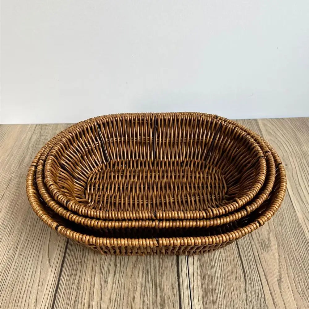 Hand-woven rattan bread basket with natural tan finish, nested stacking design, displayed on wooden surface