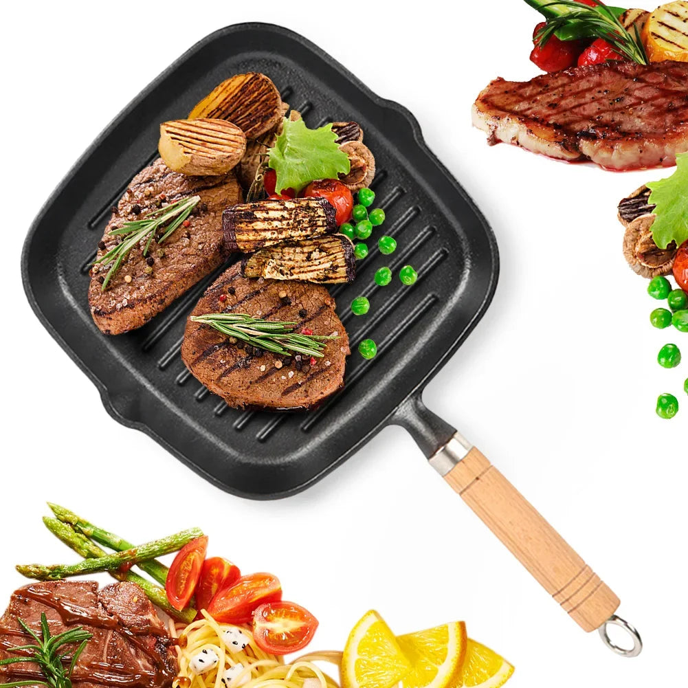 Cast iron square grill pan with wooden handle, featuring grilled steaks, vegetables, and garnishes on ridged cooking surface.