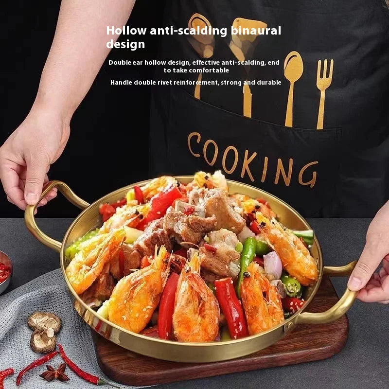 Golden stainless steel wok pan with dual handles and hollow anti-scalding design, filled with cooked shrimp and vegetables, d