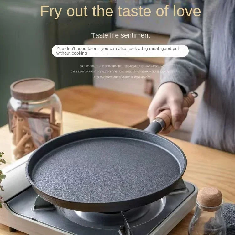 Cast iron skillet on stovetop with wooden handle, ready for cooking, displayed in bright kitchen setting