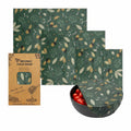 Beeswax food wrap set with three organic cotton covers in forest green autumn leaf pattern, shown with packaging and bowl of 
