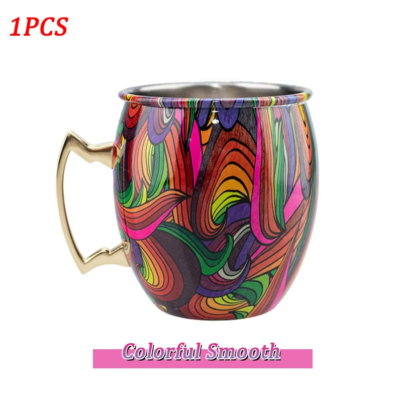 Colorful insulated copper travel mug with vibrant abstract swirl design, stainless steel interior, and gold-tone handle.