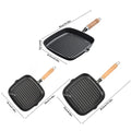 Cast iron square grill pans with wooden handles in three sizes, featuring ridged cooking surfaces and drip spouts.