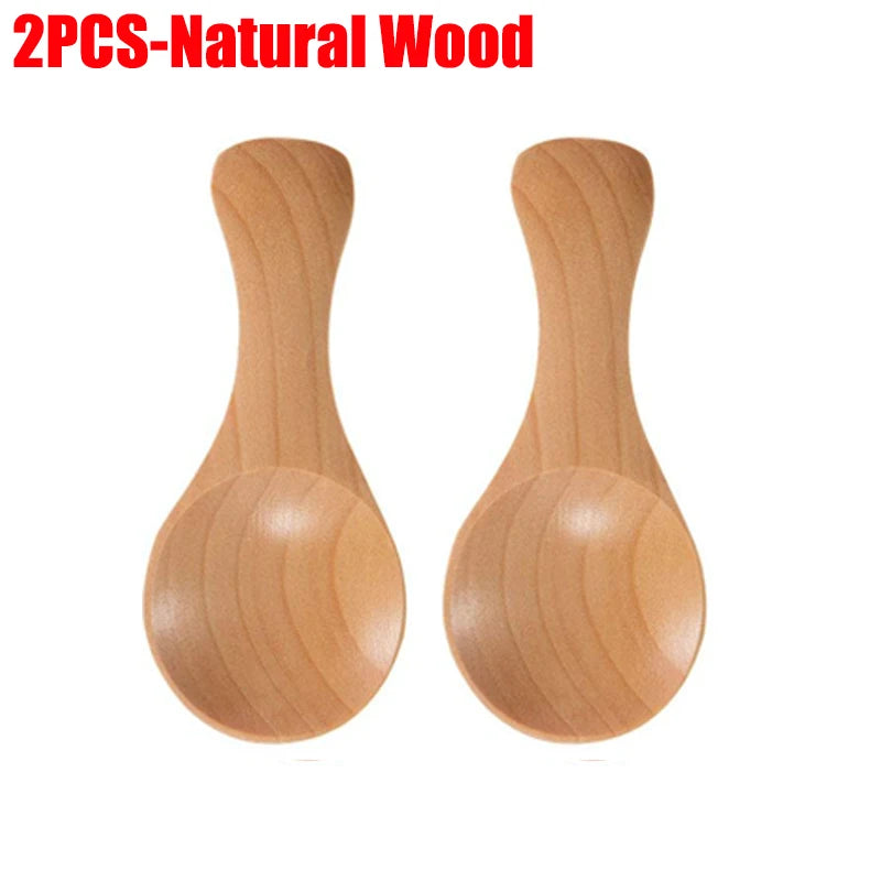 Two natural wood mini scoop spoons with rounded bowls and long handles, ideal for tea, honey, and coffee.