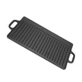 Cast iron dual-sided griddle with raised ridges and handles, black finish for indoor and outdoor grilling.