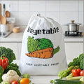 White vegetable storage bag with colorful carrot, lettuce, and tomato illustrations, surrounded by fresh produce on kitchen c