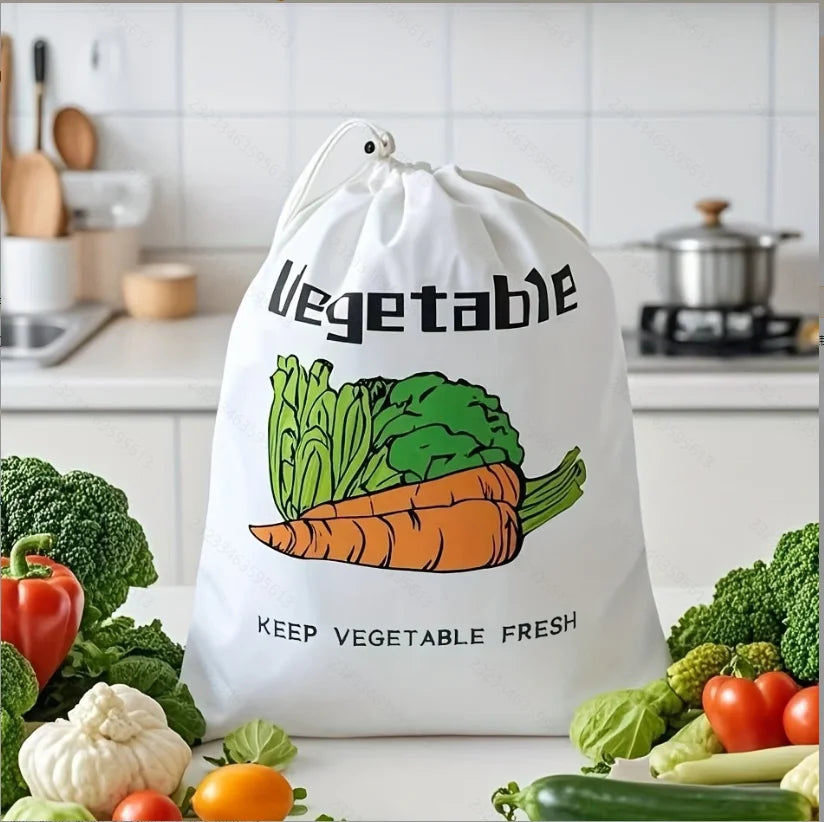 White vegetable storage bag with colorful carrot, lettuce, and tomato illustrations, surrounded by fresh produce on kitchen c