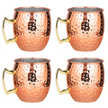 Set of four hammered copper Moscow Mule mugs with brass handles and stainless steel linings, featuring textured finish.