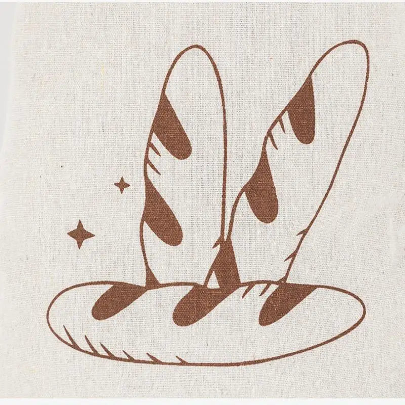 Handmade organic linen bread bags with illustrated baguettes and loaves design, reusable eco-friendly kitchen storage.