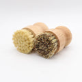 Two wooden dish brushes with natural bristles, one with light bristles and one with dark bristles, featuring replaceable head