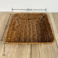 Hand-woven rattan bread basket with natural tan finish, measuring 20cm x 9cm, displayed on wooden surface.