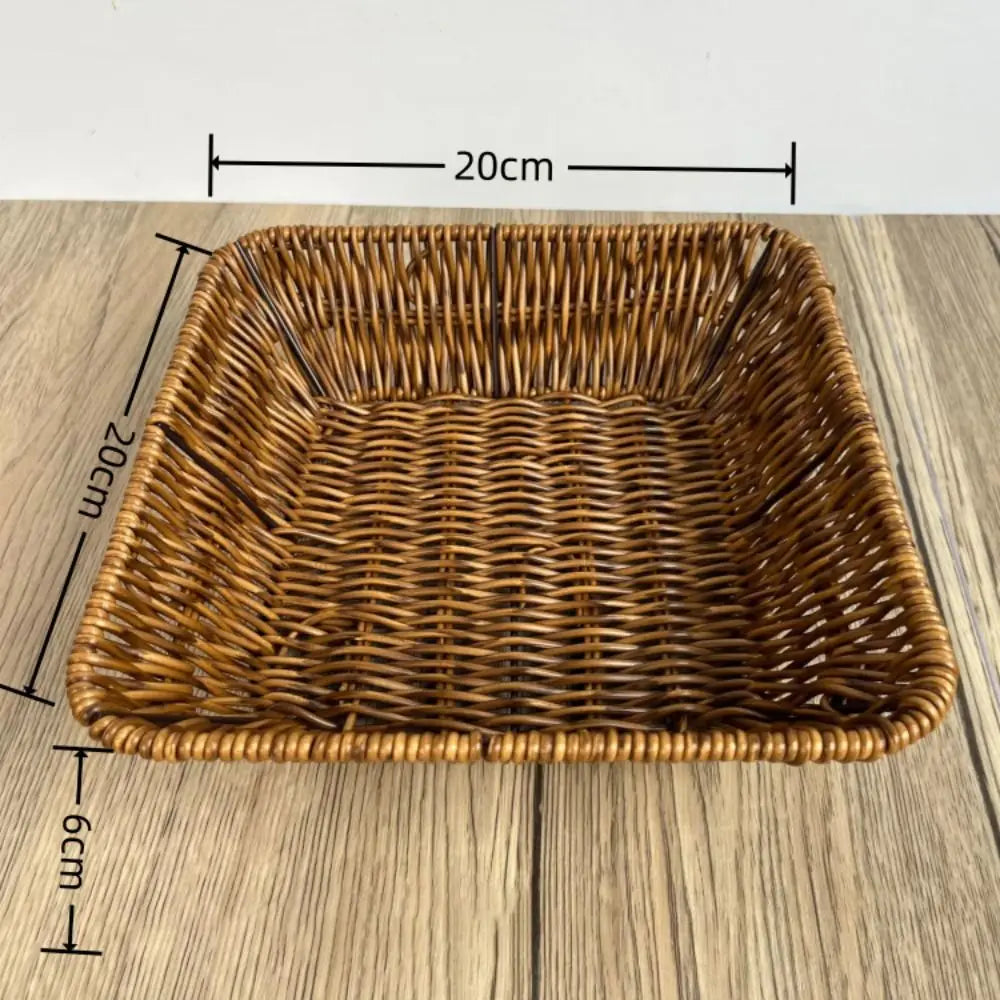 Hand-woven rattan bread basket with natural tan finish, measuring 20cm x 9cm, displayed on wooden surface.