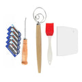 Natural rattan bread proofing basket with wooden tools, silicone brush, dough scraper, and replacement blades on white backgr