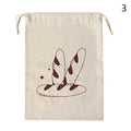 Beige linen bread bag with burgundy illustrated baguettes and decorative stars, drawstring closure for reusable organic loaf 