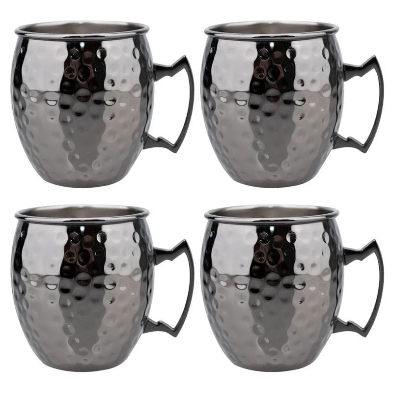 Four hammered stainless steel Moscow Mule mugs with handles, featuring a polished metallic finish and textured surface design