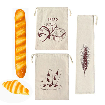 Three cream linen bread bags with brown bread illustrations, displayed with fresh baguette and croissant examples.
