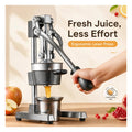 Hand pulling the long lever of the cast iron citrus press, juice running into the stainless steel cup below
